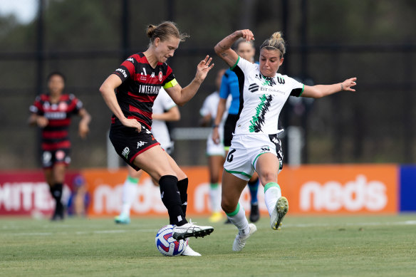 Clare Hunt playing for the Wanderers in January against Chloe Logarzo.