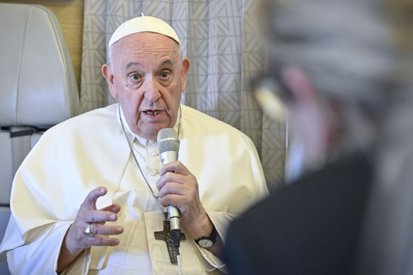 Pope Francis answers reporters questions during a news conference aboard the papal plane on his flight back to Rome after visiting Nur-Sultan, Kazakhstan.