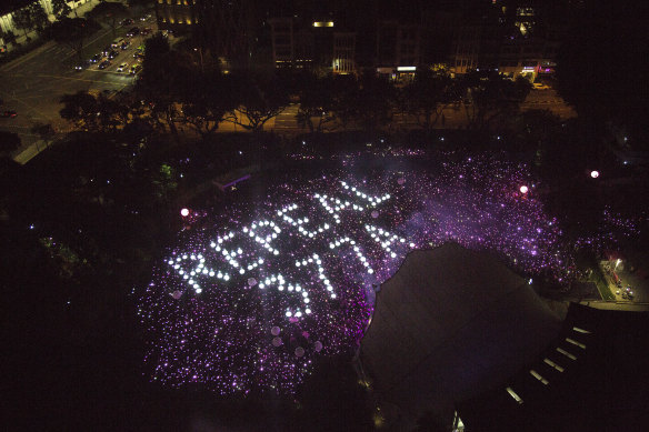 Demonstrators form the characters Repeal 377A in a call to repeal Section 377A of Singapore’s Penal Code which criminalises sex between men during a Pink Dot event held in Hong Lim Park in 2019.
