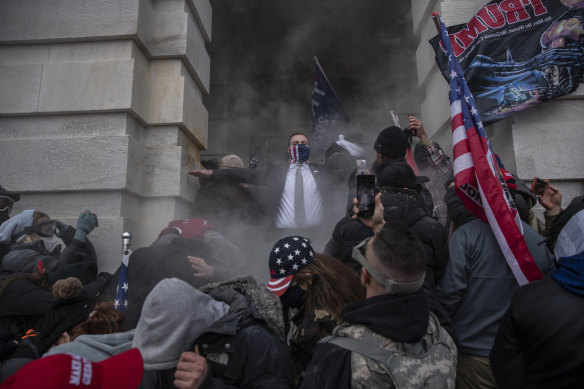 Demonstrators attempt to breach the US Capitol building in Washington on Wednesday.