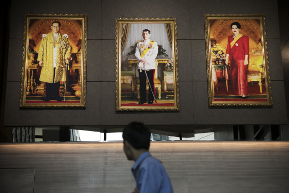 Portraits of the king flanked by his late father, Bhumibol, and his mother, Sirikit, at the Stock Exchange of Thailand in 2019.
