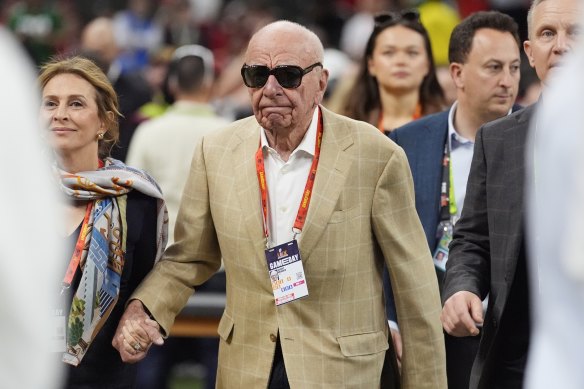 Rupert Murdoch walks on the sidelines before the Super Bowl.