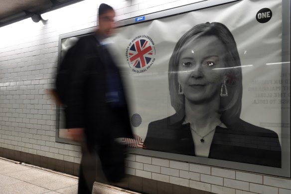 A pedestrian passes a billboard advertisement for Liz Truss, outgoing UK prime minister, in October 2022.