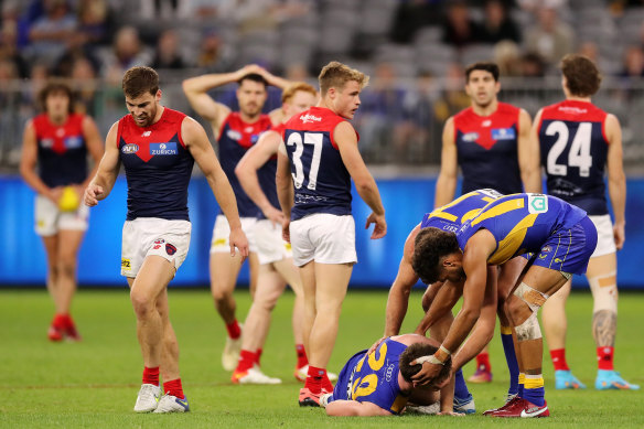 Luke Foley of the Eagles lies on the ground after a tackle from Kade Chandler.