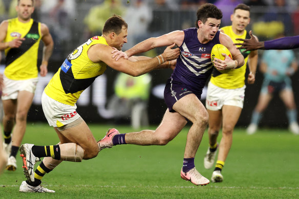 Andrew Brayshaw of the Dockers fends off Toby Nankervis of the Tigers.