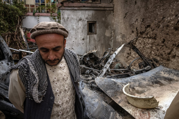 A relative turns away after viewing the destruction of the home destroyed by a US drone, a strike the US now admits only killed innocent civilians.