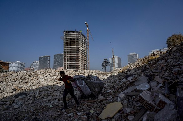 A worker carries debris from a high-rise apartment construction site in Istanbul. 