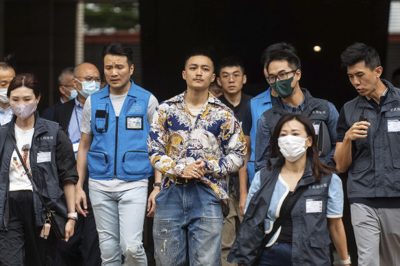 Lee Yue-shun (centre), a former pro-democracy district councillor, leaves the West Kowloon Magistrates’ Courts in Hong Kong last month after being cleared of national security charges. Fourteen activists were convicted.