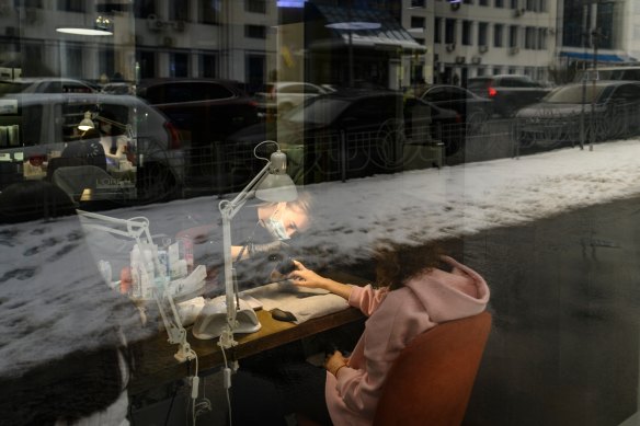 A woman gets a manicure at a salon in Kyiv on Friday as life continues as usual in the Ukrainian capital.