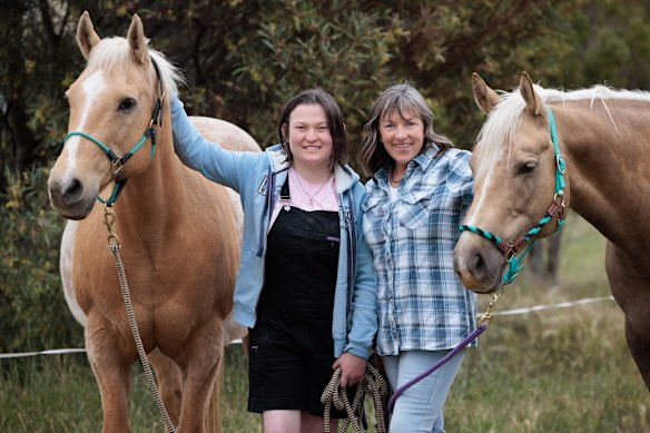 Author Rachael Treasure with her daughter, Rosie, and two of the family’s horses.