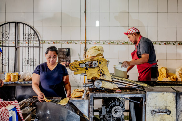 Erika Flores and Luis Flores make tortillas in Mexico City.