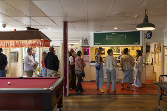 Order your meal at the counter near the pool table. 