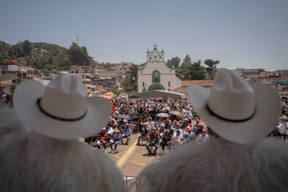 PRI candidates look at rally attendees in San Juan Chamula, Mexico.