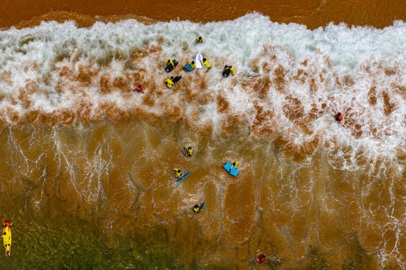 Surf school students at Mona Vale beach on Monday.