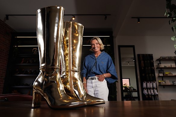 Anna Baird, founder of Bared Shoes with boots worn by Kylie Minogue at her store in Malvern.