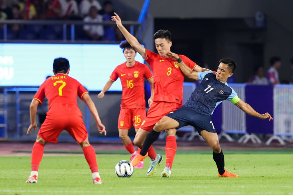 Sunil Chhetri tussles for the ball last year playing against China.