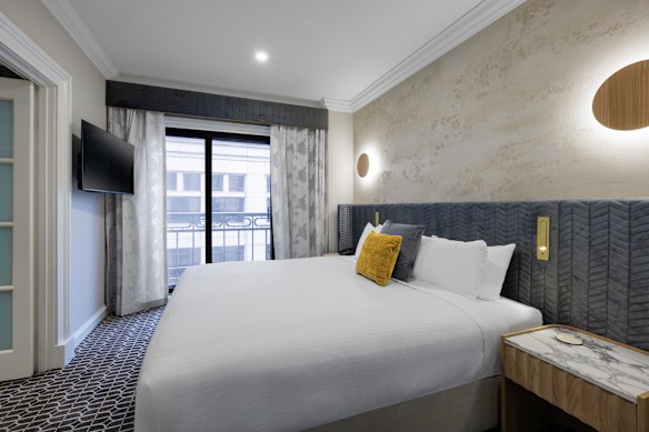 The well-sized bedroom has views across Melbourne to skyscrapers beyond.