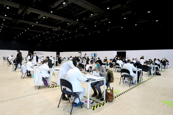 Health workers register people at a  vaccination centre in Rome.