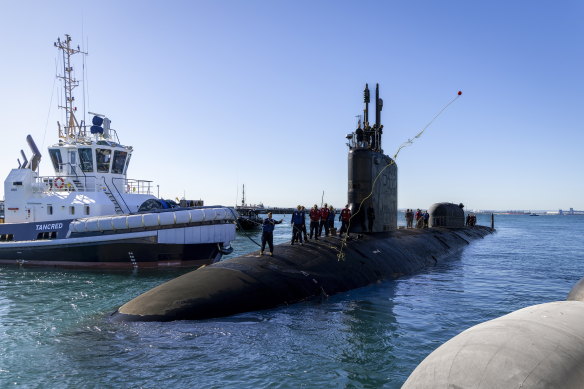 A crew member of the Virginia-class submarine USS North Carolina throws a line ashore at Fleet Base West, Western Australia.