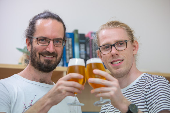 UQ Associate Professor Ben Schulz (left) with PhD researcher Ed Kerr and some experimental material.