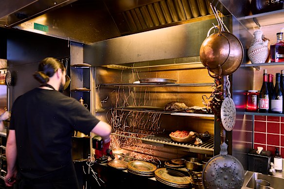 Chef Tom Sarafian working the wood grill at Zareh.