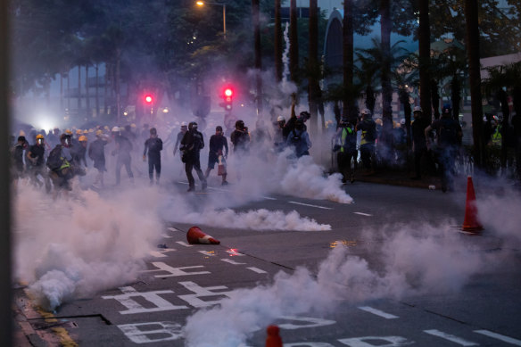 Riot police deploy tear gas during a protest in the Wan Chai district of Hong Kong on Sunday night.
