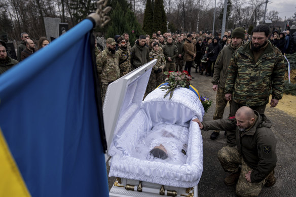 Ukrainian soldiers of the Khartia Battalion line up to offer final greetings to their comrade Vladyslava Chernyh