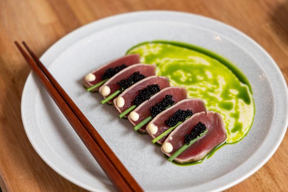 Tuna carpaccio featuring square slices of aged tuna carefully garnished with flying fish roe, chives and spiced yuzu mayo.