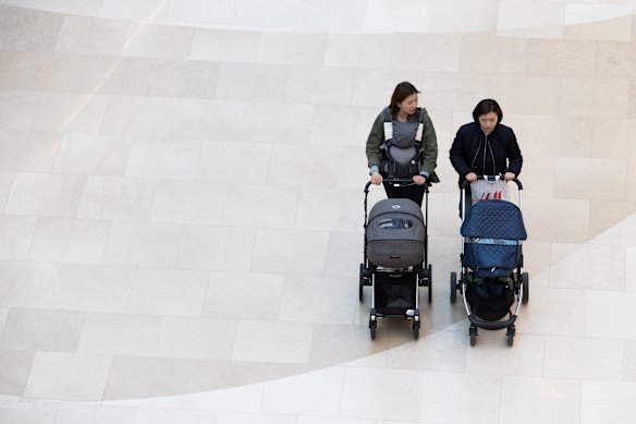 Two women push baby strollers in the Starfield Hanam shopping complex in Hanam, Gyeonggi, South Korea.