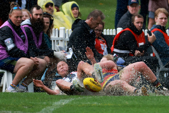 Joanna Lin of the Magpies is tackled by Abbie Ballard of the Crows during the 2022 semi-final match at Unley Oval.