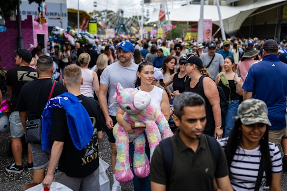 Jennifer walks with a giant unicorn that her partner Anthony won for her on Friday.