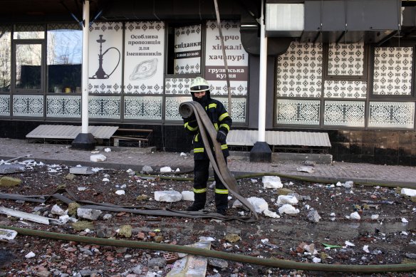 Firefighters tend to a damaged residential building following Russian missile strikes in Kyiv.