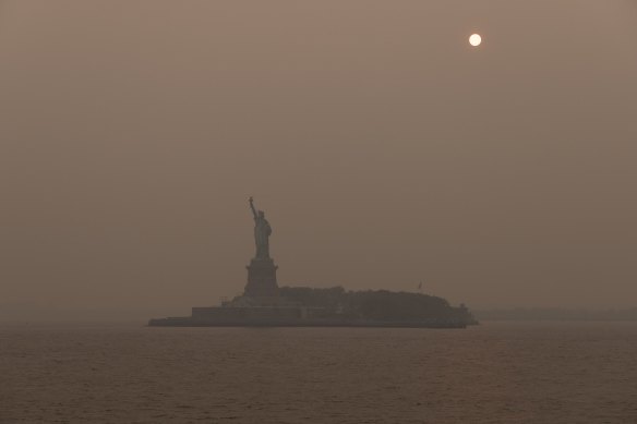 The Statue of Liberty shrouded in smoke from Canada wildfires in New York.