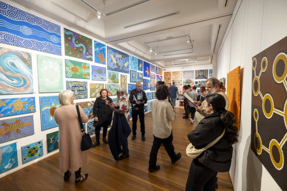 Visitors at Confined 15, an exhibition of artworks from Indigenous artists who are currently in jail or recently released, in Glen Eira City Council Gallery.