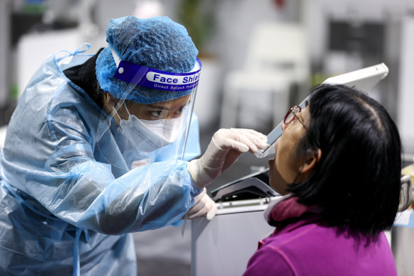 A traveller receives a COVID-19 test at a testing clinic.