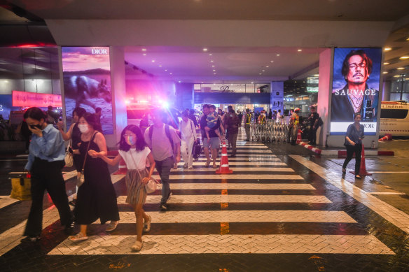 People leave the shopping centre after shots were fired.