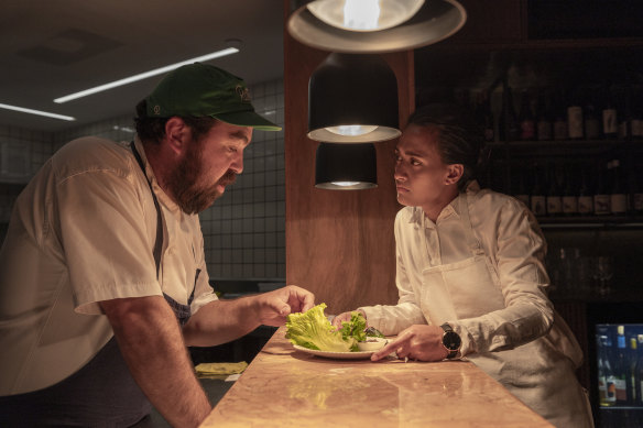 Bar Heather chef Ollie Wong-Hee explains the menu to a new staff member.