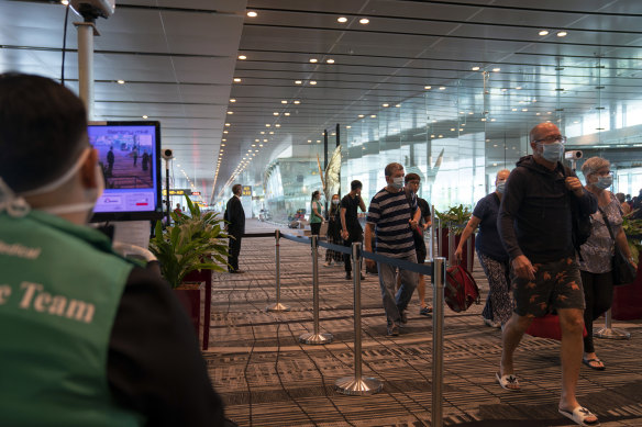 Passengers are screened on arrival at Singapore's Changi Airport. 