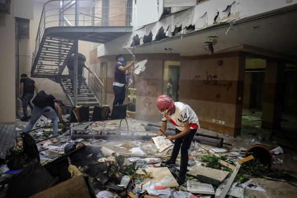 Protesters break into the Lebanese Banks Association (ABL) headquarters during a demonstration in Beirut on Saturday.