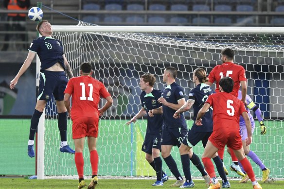 Australia’s Harry Souttar heads the ball during a qualifying soccer match against Palestine.