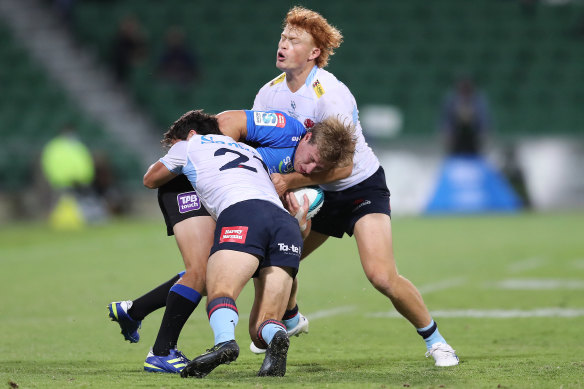 Jack Grant and Tane Edmed wrap up Jake McIntyre.