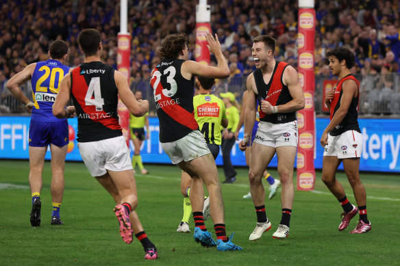 The Bombers celebrate a Zach Merrett goal.