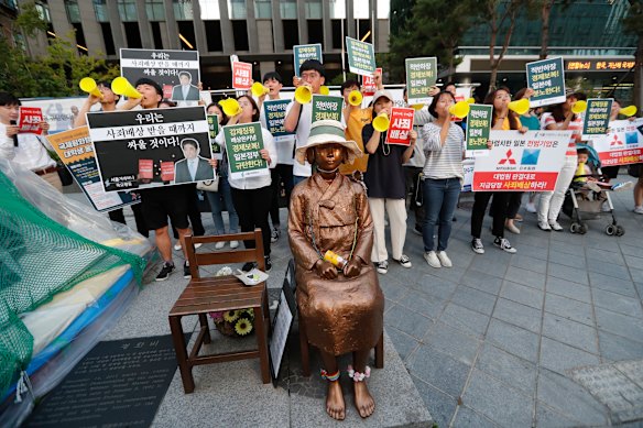 Students denounce Japan’s exports control on South Korea in 2019, near a statue of a girl symbolising wartime “comfort women” in front of the Japanese embassy in Seoul.