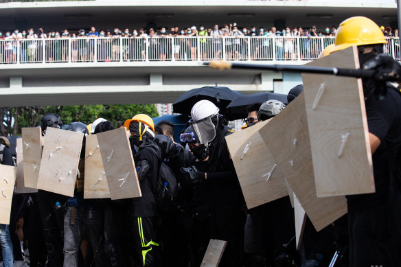 Demonstrators hold makeshift shields and umbrellas during a protest in the Yuen Long district of the New Territories in Hong Kong on Saturday.