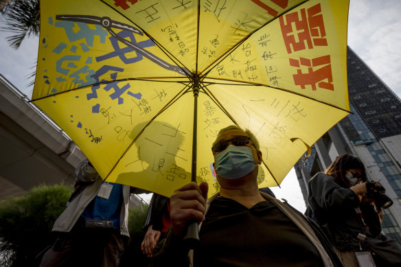 A pro-democracy demonstrator waits outside the West Kowloon Magistrates’ Courts as the group was charged in 2021.
