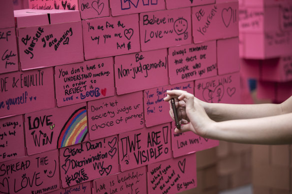 Messages of hope fill a board at a Pink Dot event in Singapore in 2019. 