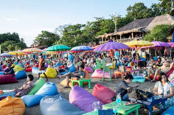 Tourists at a beach club in Seminyak, Bali.