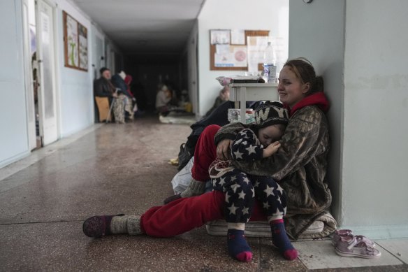 Anastasia Erashova cries as she hugs her child in a corridor of a hospital in Mariupol. Anastasia’s other child was killed during Russian shelling of the city.
