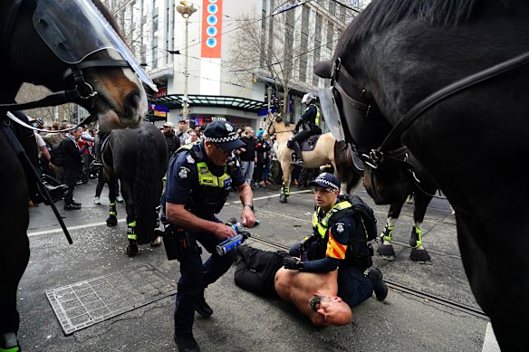 Police grapple with a protester on Sunday.