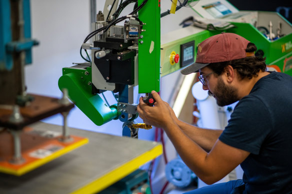 A worker prepares the composite material heat welder in Victoria, British Columbia. Canada needs more hands on deck.